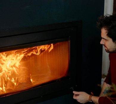 Homme devant un feu de cheminée